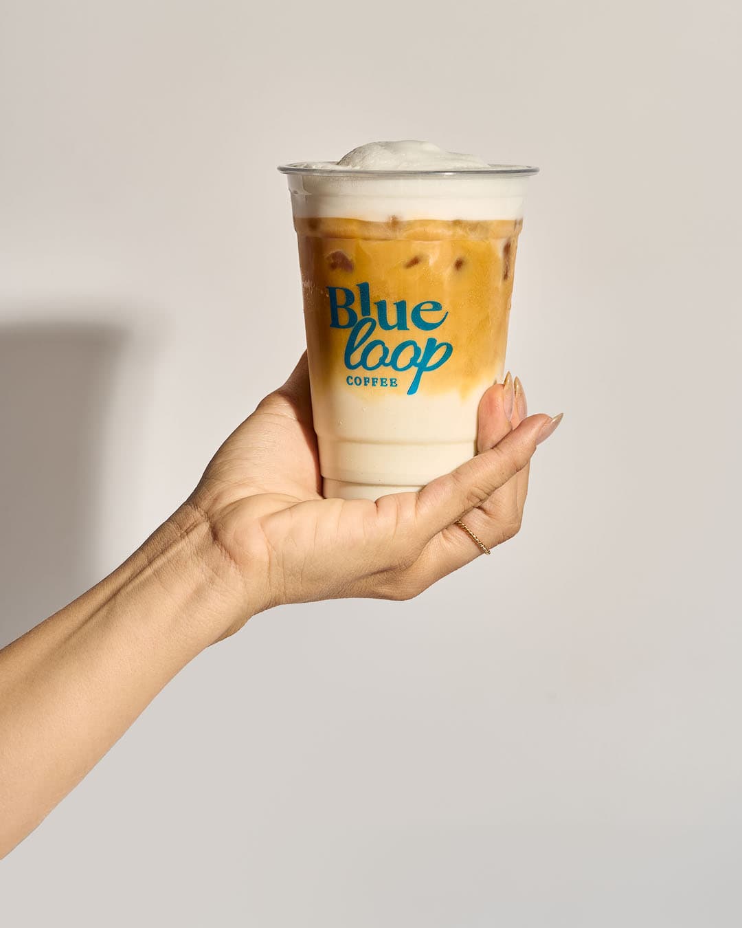 Iced coffee from Blueloop Coffee Playa San Juan in Alicante, served in a branded cup